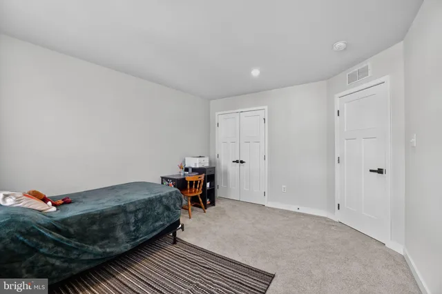 a bed room with a bed and a chair