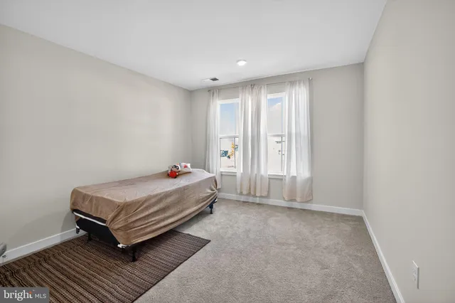 a room with a bed and window