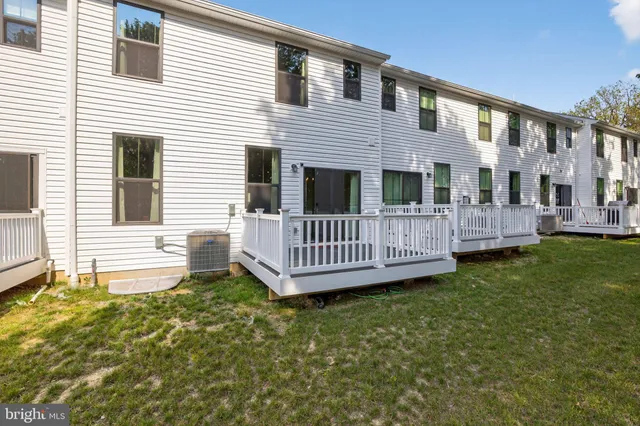 a view of a house with a yard and deck