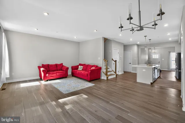 a living room with furniture and kitchen view