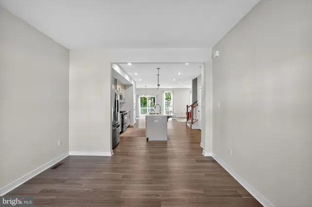 a view of a living room with wooden floor