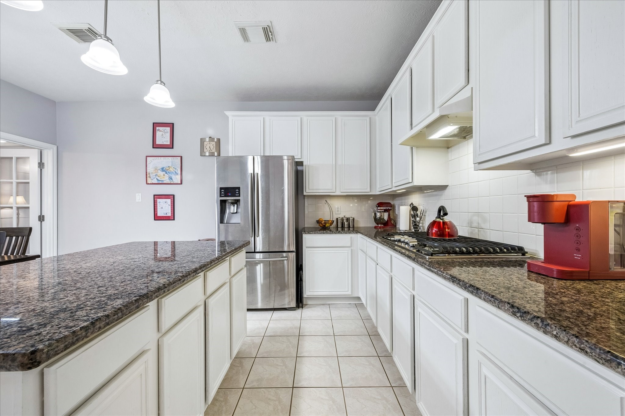 12423 Rutgers Park Court Houston, TX 77058 - Photo 12 of 29 a kitchen with granite countertop a refrigerator a sink and dishwasher