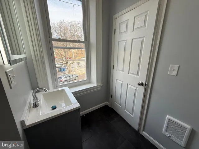 a bathroom with a sink window and tub