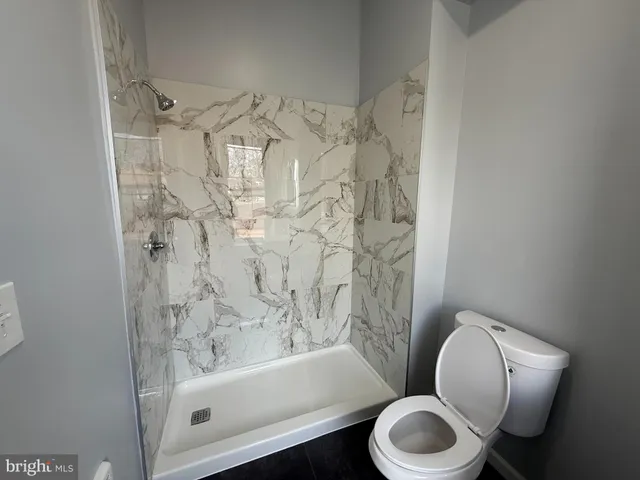a bathroom with a toilet and a bathtub
