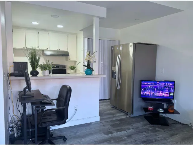 a kitchen with stainless steel appliances granite countertop a refrigerator and a stove top oven