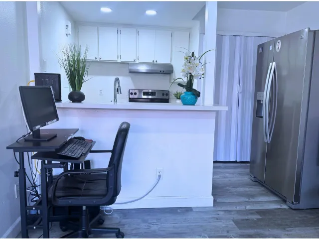 a kitchen with stainless steel appliances granite countertop a refrigerator and a stove top oven
