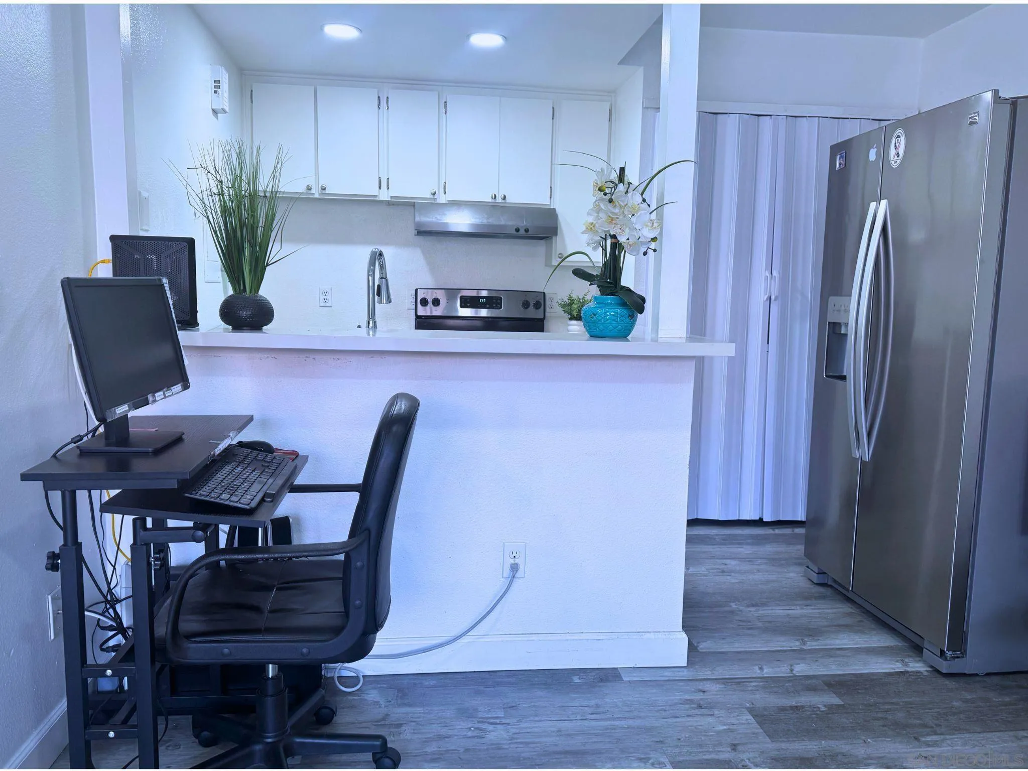 875 West San Ysidro Boulevard, Unit 14 San Ysidro, CA 92173 - Photo 17 of 21 a kitchen with stainless steel appliances granite countertop a refrigerator and a stove top oven