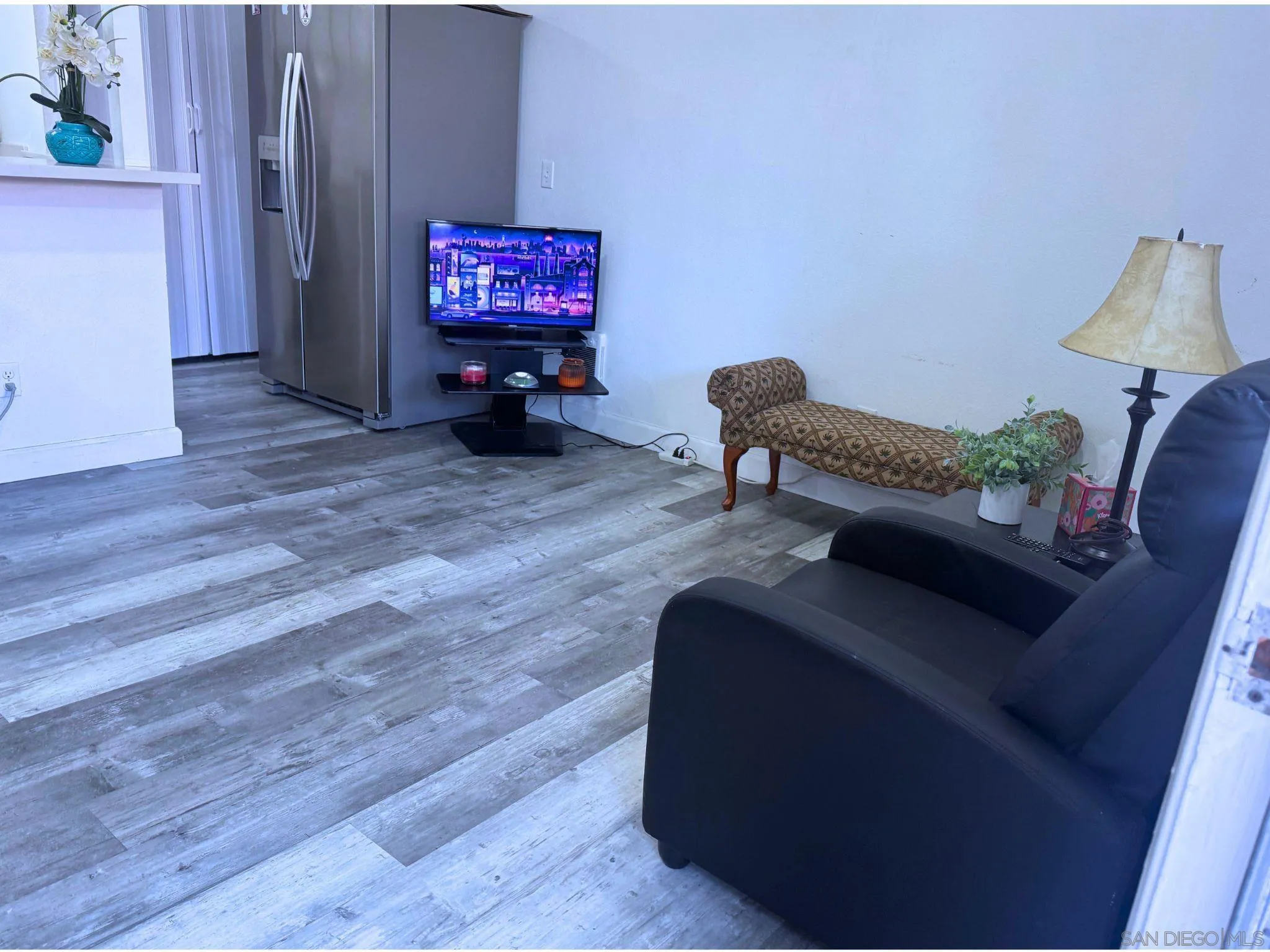 875 West San Ysidro Boulevard, Unit 14 San Ysidro, CA 92173 - Photo 18 of 21 a living room with furniture and a flat screen tv