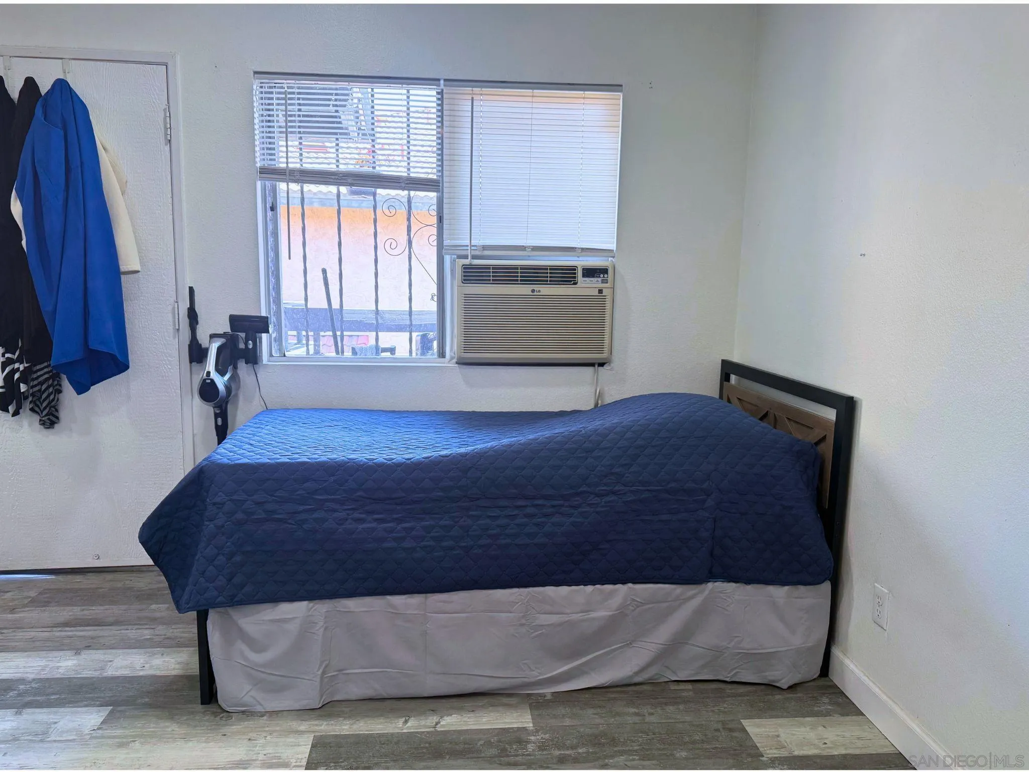875 West San Ysidro Boulevard, Unit 14 San Ysidro, CA 92173 - Photo 20 of 21 a bedroom with a bed and window