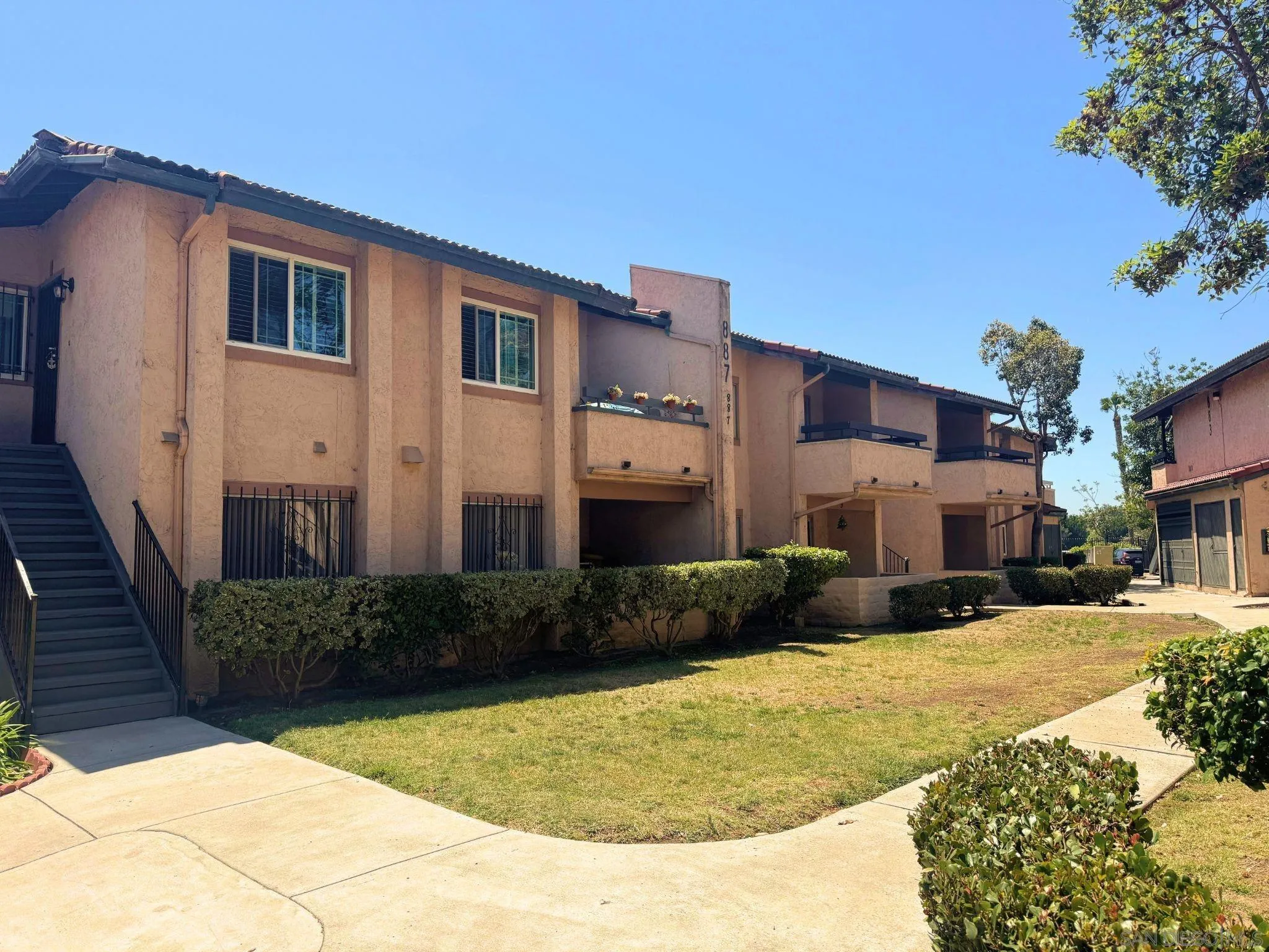 875 West San Ysidro Boulevard, Unit 14 San Ysidro, CA 92173 - Photo 5 of 21 a front view of a house with a yard
