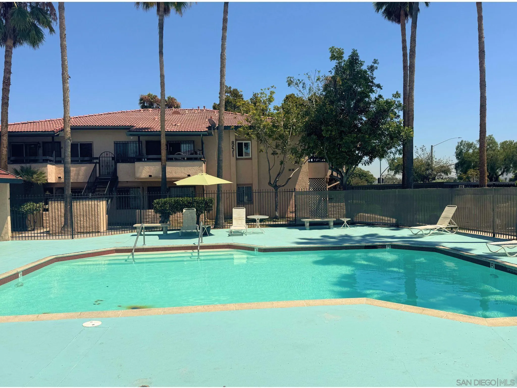 875 West San Ysidro Boulevard, Unit 14 San Ysidro, CA 92173 - Photo 6 of 21 a view of a swimming pool with a yard