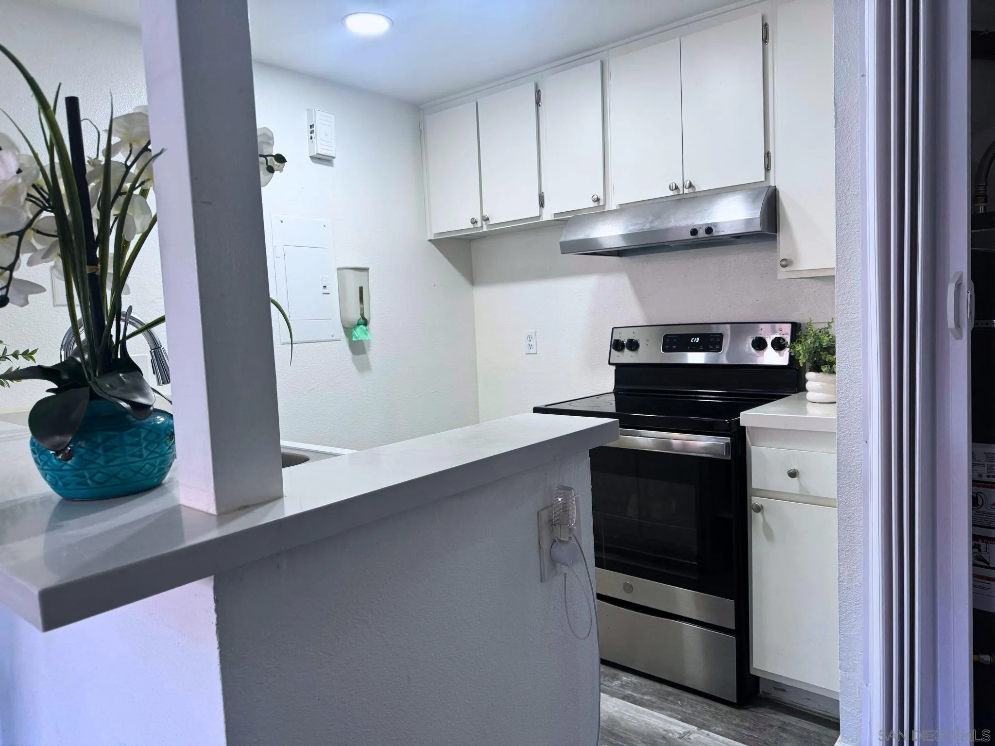 875 West San Ysidro Boulevard, Unit 14 San Ysidro, CA 92173 - Photo 10 of 21 a kitchen with stainless steel appliances granite countertop a stove a microwave and cabinets