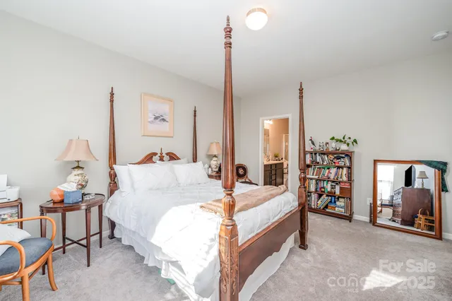 a bed room with a bed and a chair