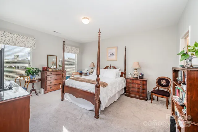 a bedroom with bed and a table