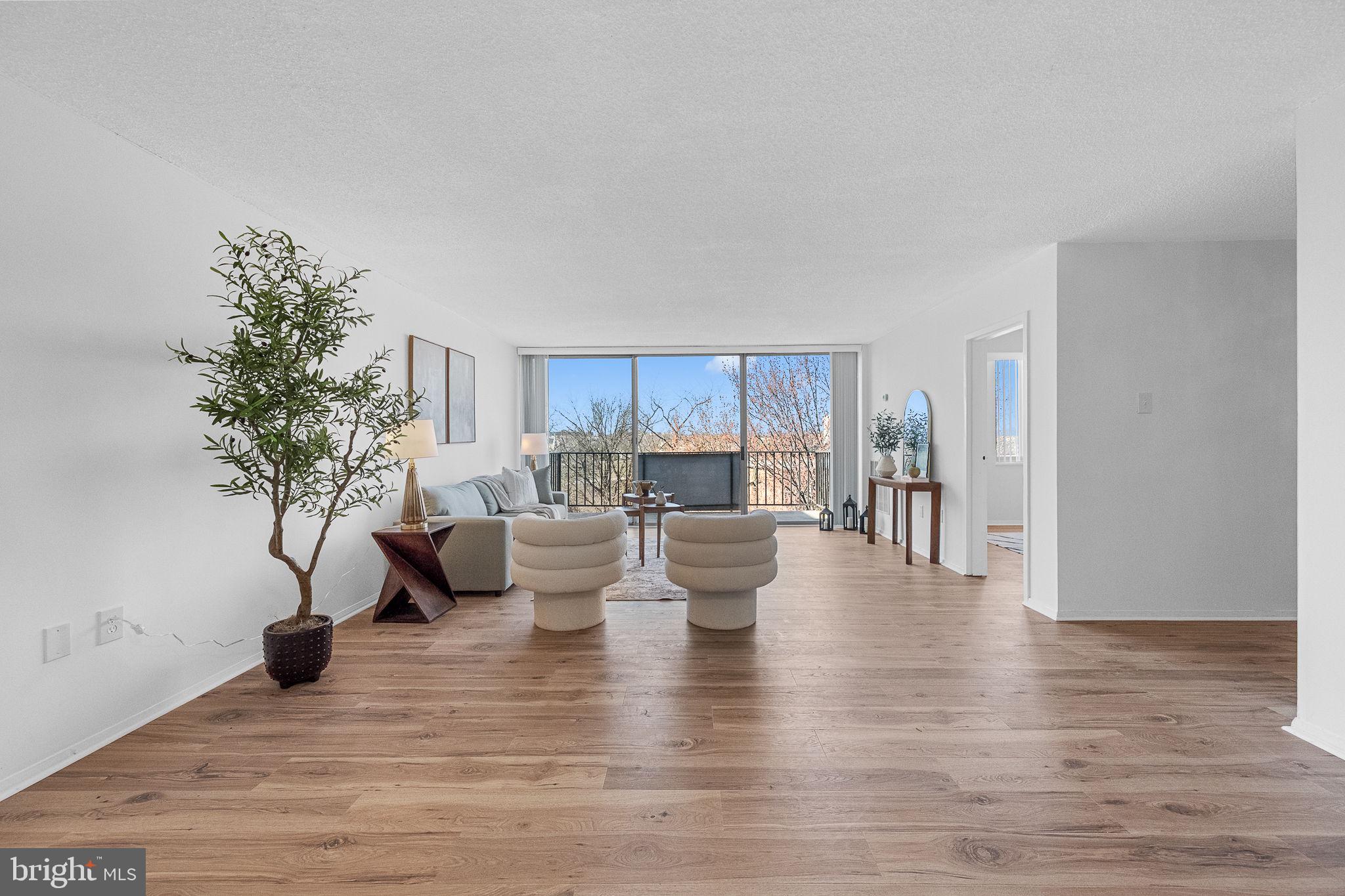 1515 South Arlington Ridge Road, Unit 703 Arlington, VA 22202 - Photo 11 of 44 a living room with furniture and a potted plant