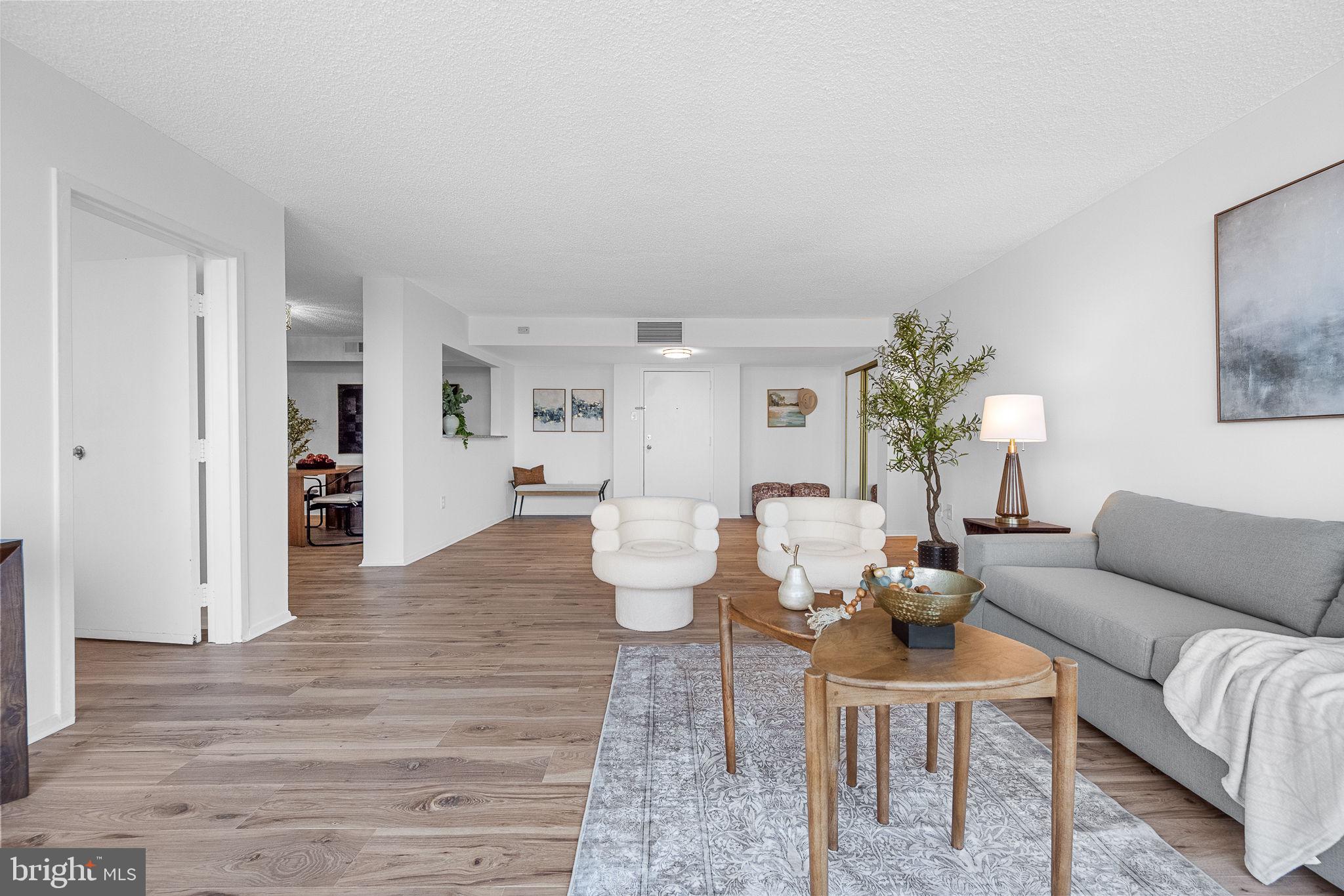 1515 South Arlington Ridge Road, Unit 703 Arlington, VA 22202 - Photo 14 of 44 a living room with furniture and wooden floor