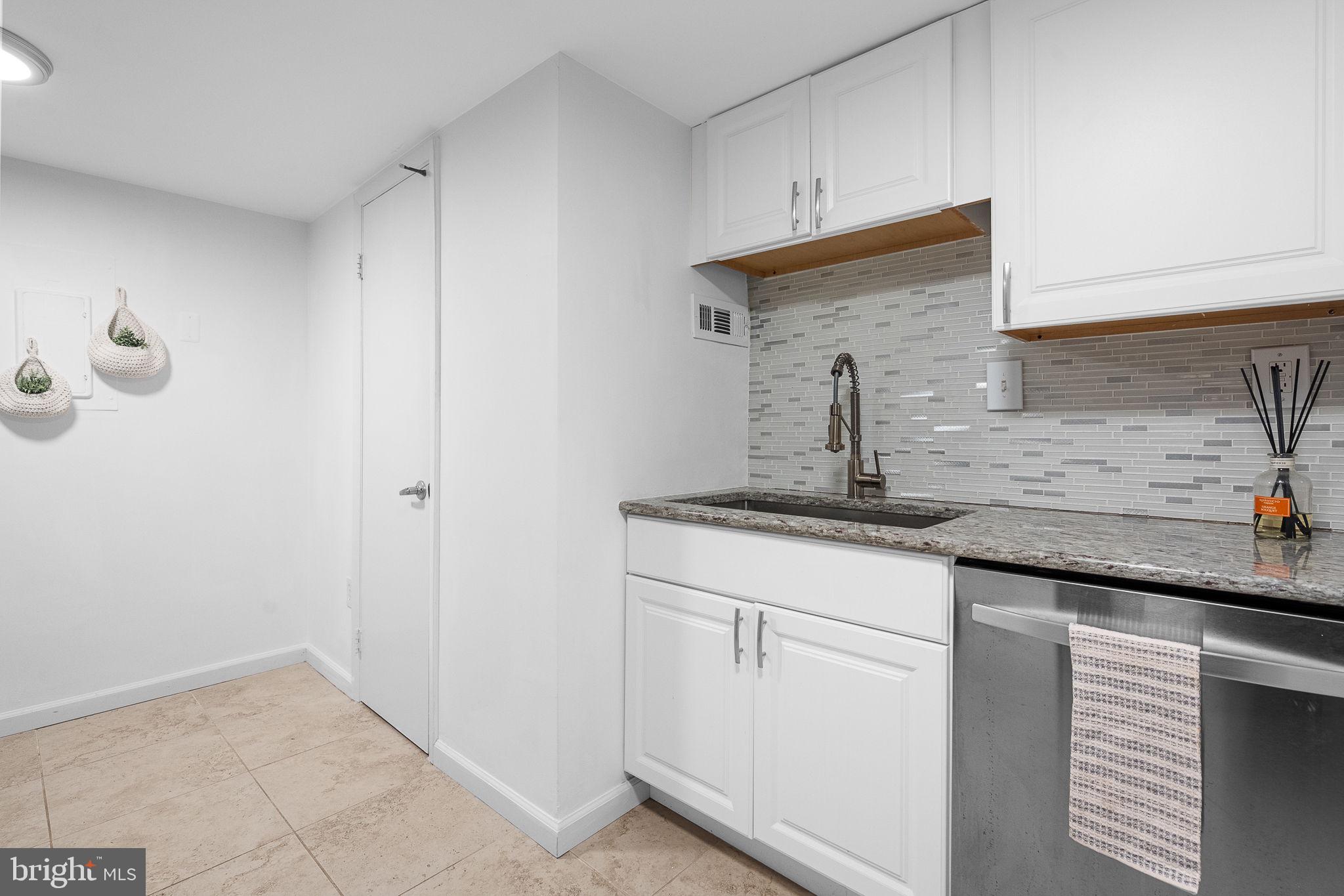 1515 South Arlington Ridge Road, Unit 703 Arlington, VA 22202 - Photo 19 of 44 a kitchen with granite countertop a sink and cabinets