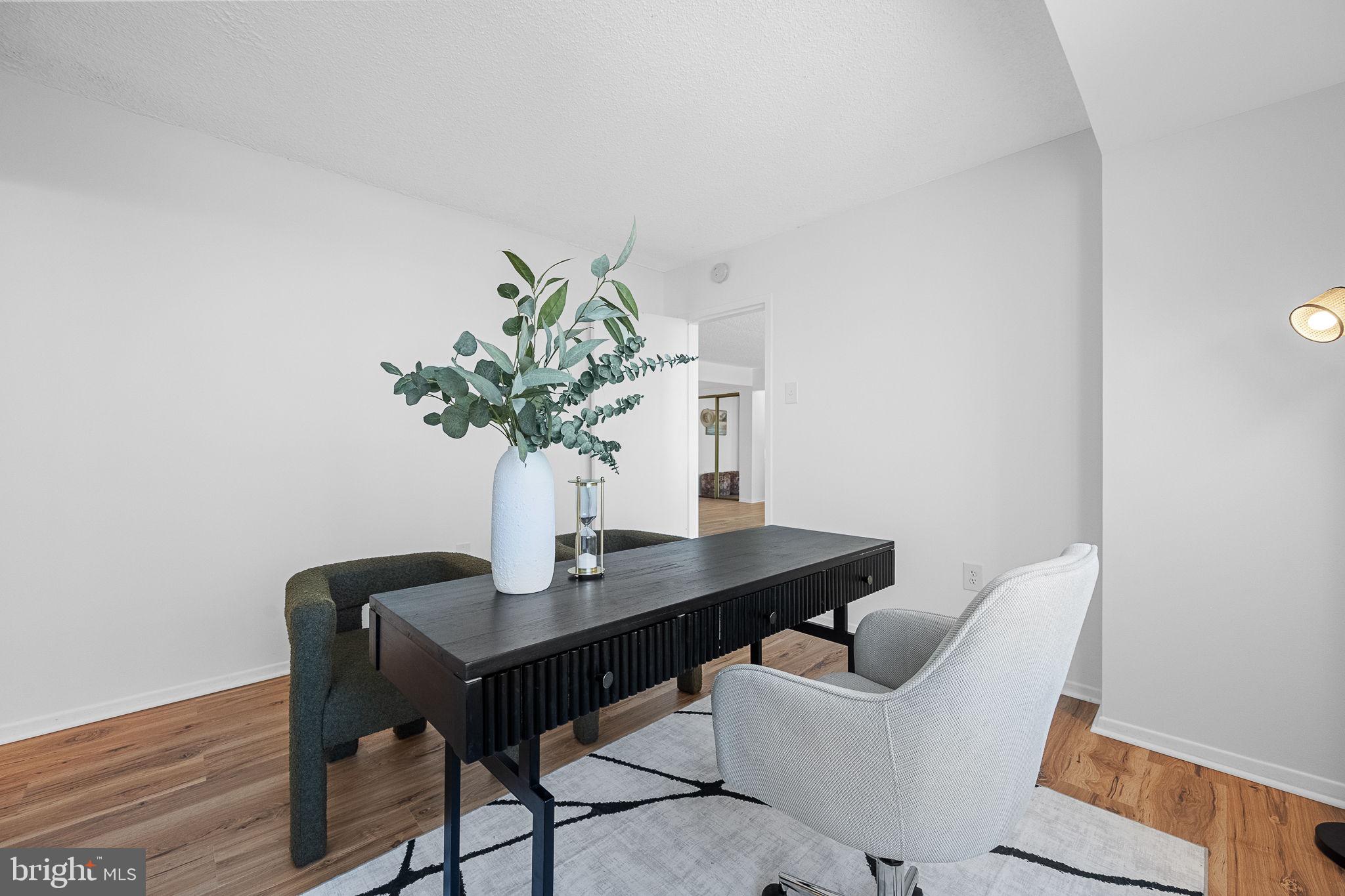 1515 South Arlington Ridge Road, Unit 703 Arlington, VA 22202 - Photo 23 of 44 a dining room with furniture and wooden floor