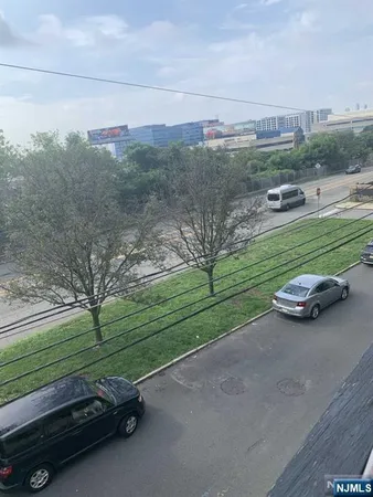 a view of a park with large trees