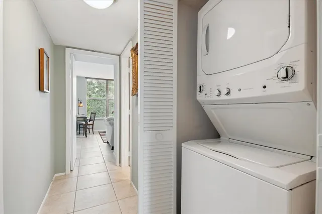a view of washer and dryer with bathroom in the background
