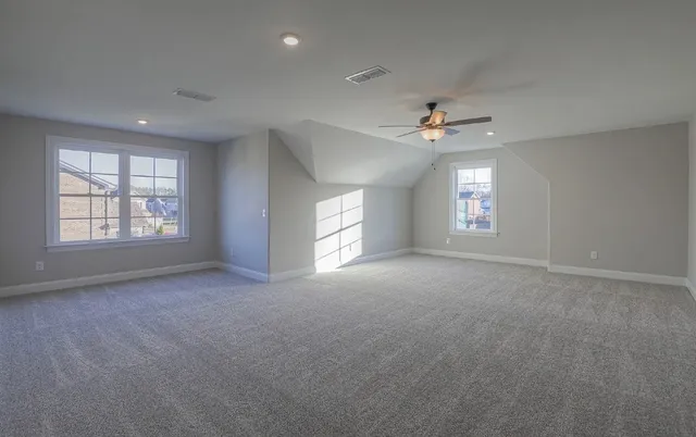 an empty room with a empty space and windows