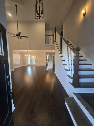 a view of entryway and hall with wooden floor