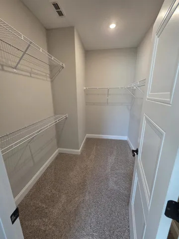 a spacious bathroom with a double vanity sink a mirror and shower