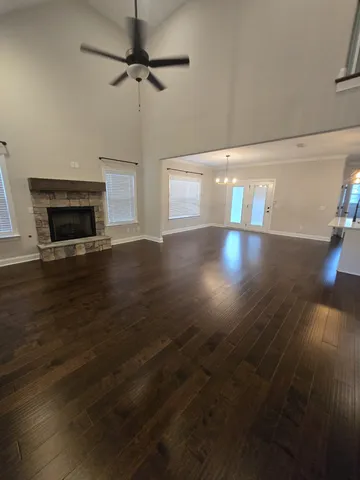 a view of empty room with wooden floor and fireplace
