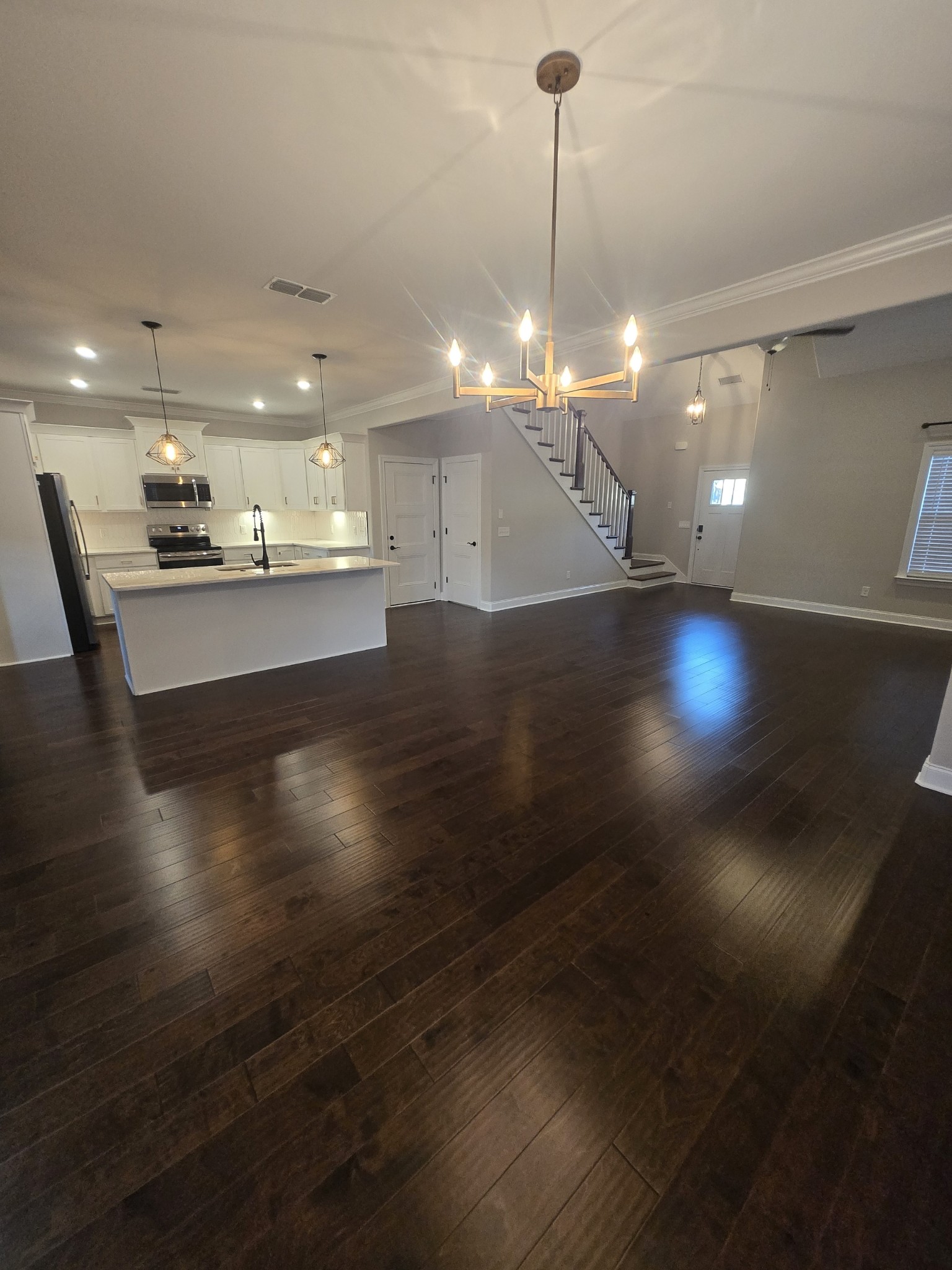 453 Ruby Oaks Lane Murfreesboro, TN 37128 - Photo 7 of 34 a view of a room with wooden floor kitchen view and a chandelier