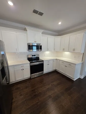 a kitchen with a sink a stove and cabinets
