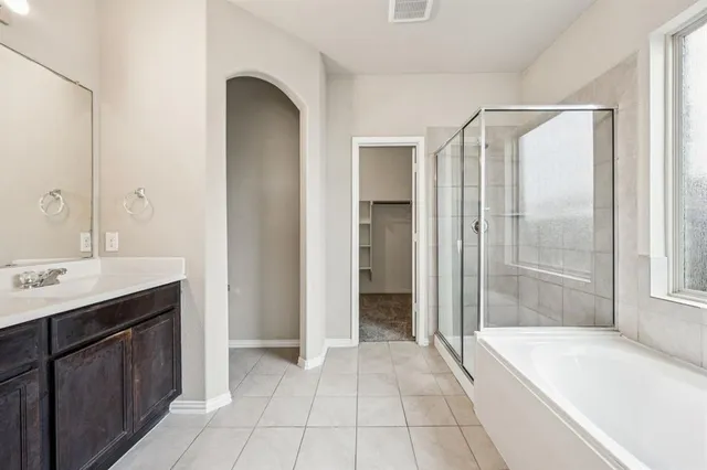 a spacious bathroom with a shower and a sink