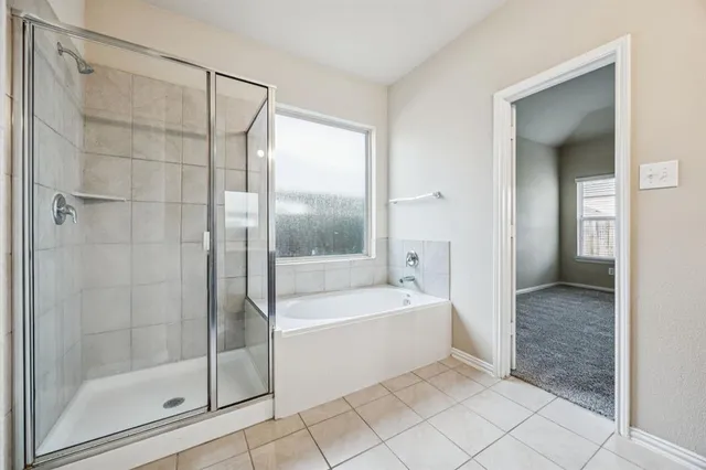a bathroom with a bathtub and a shower