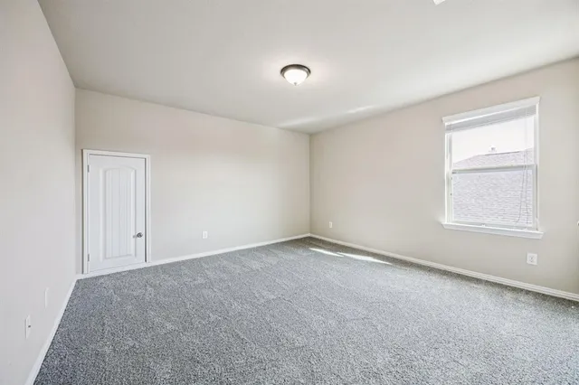 a view of an empty room and a window