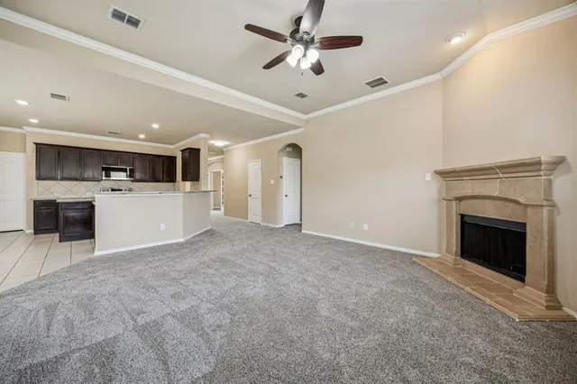 a view of a kitchen with a sink and a fireplace