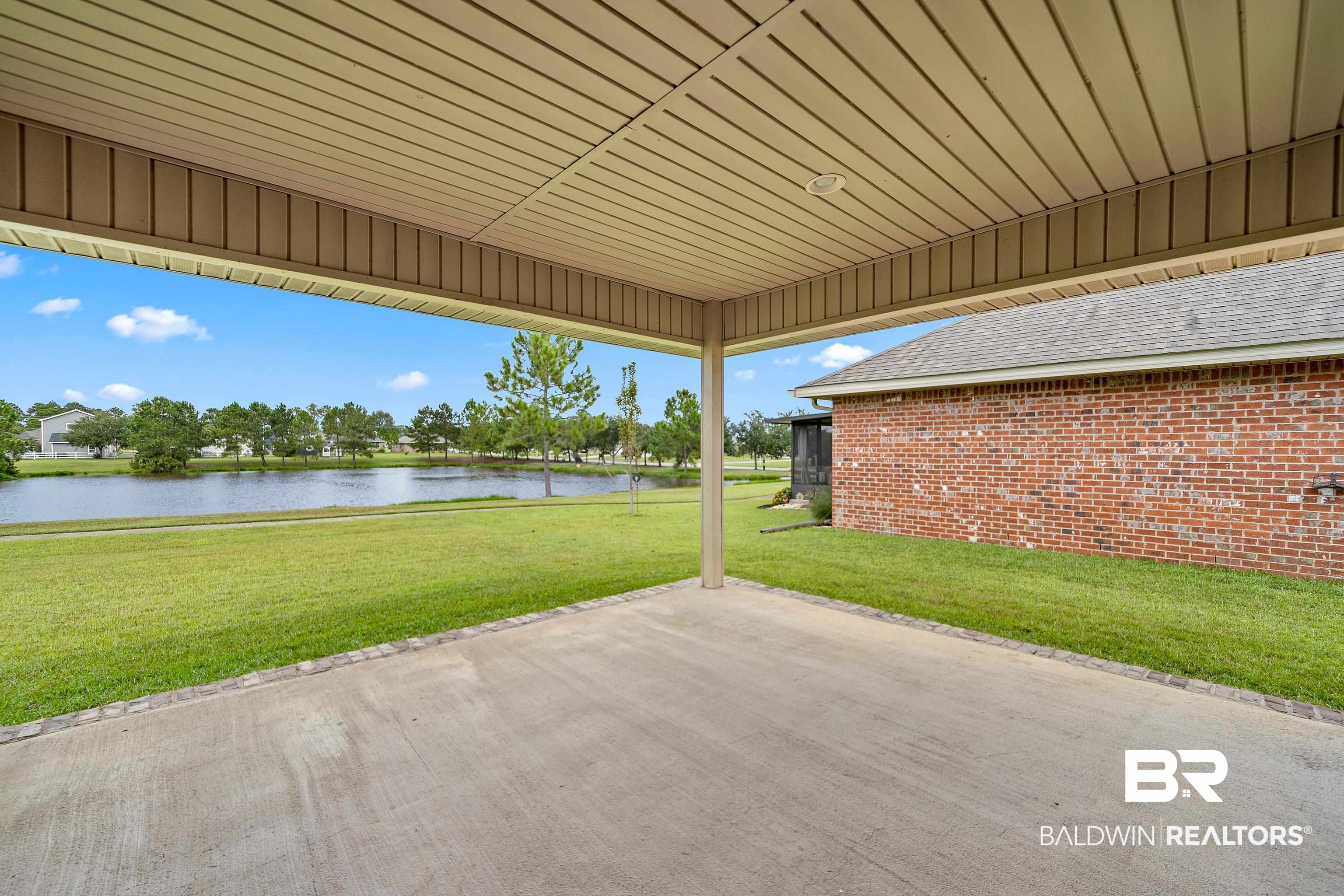 22631 Lake South Drive Foley, AL 36535 - Photo 19 of 25 View of patio / terrace with a water view