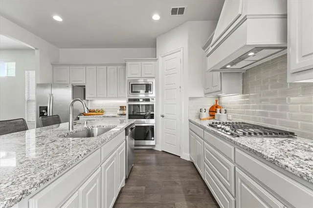 a kitchen with counter top space and living room