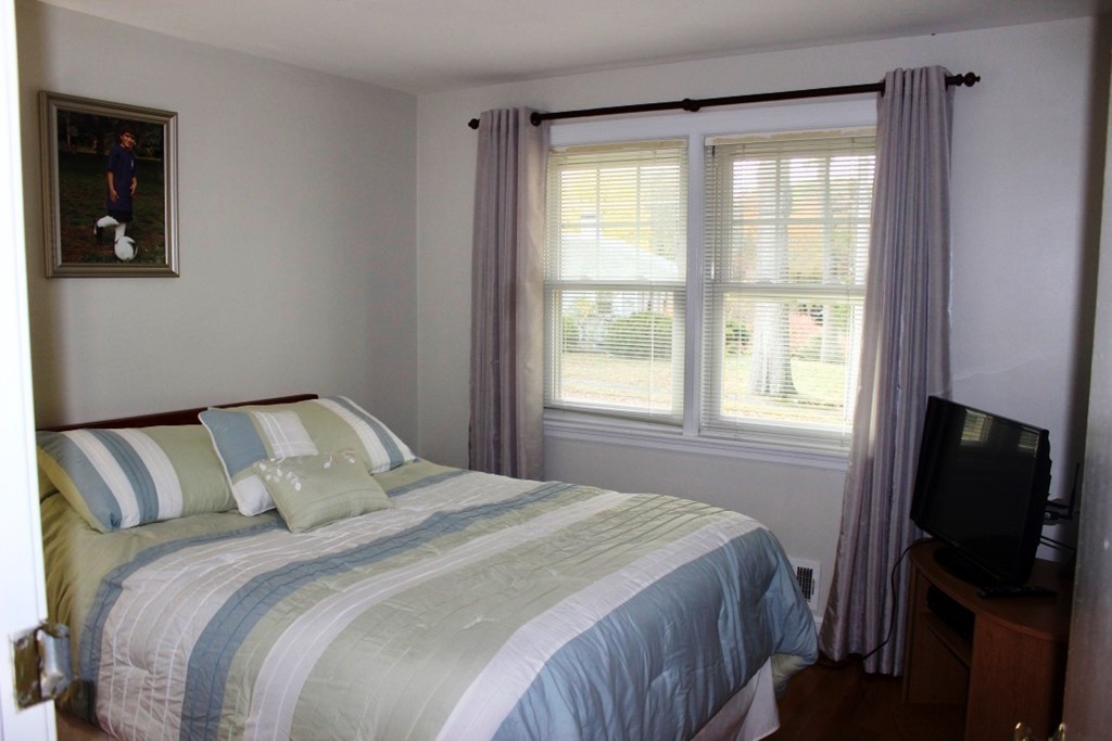 20 Poplar Road Wellesley, MA 02482 - Photo 13 of 27 a bedroom with a bed and a flat tv screen