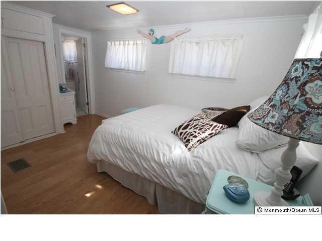 814 Sinclair Road Point Pleasant, NJ 08742 - Photo 11 of 23 a bedroom with a bed and a window