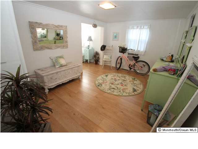 814 Sinclair Road Point Pleasant, NJ 08742 - Photo 14 of 23 a living room with furniture and a mirror
