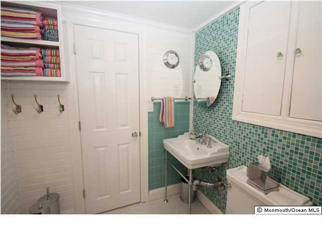 814 Sinclair Road Point Pleasant, NJ 08742 - Photo 19 of 23 a bathroom with a sink a mirror and shower
