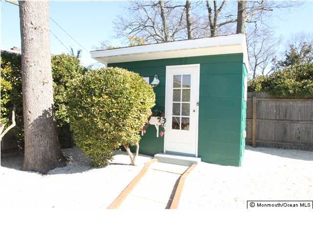 814 Sinclair Road Point Pleasant, NJ 08742 - Photo 20 of 23 a front view of a house with a yard and garage