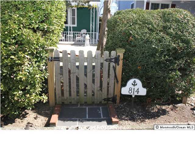 814 Sinclair Road Point Pleasant, NJ 08742 - Photo 2 of 23 a wooden bench sitting in front of a building
