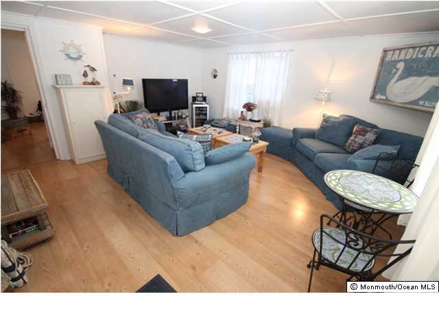 814 Sinclair Road Point Pleasant, NJ 08742 - Photo 10 of 23 a living room with furniture and a flat screen tv