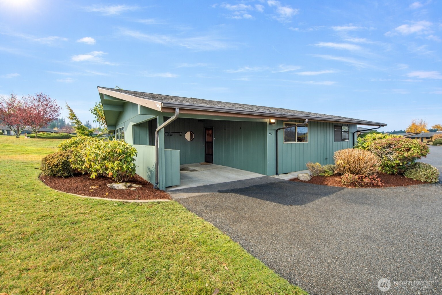 1301 South 3rd Avenue, Unit 19D Sequim, WA 98382 - Photo 1 of 35 a front view of a house with a yard and garage