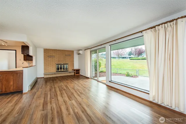 a view of a room with wooden floor and door