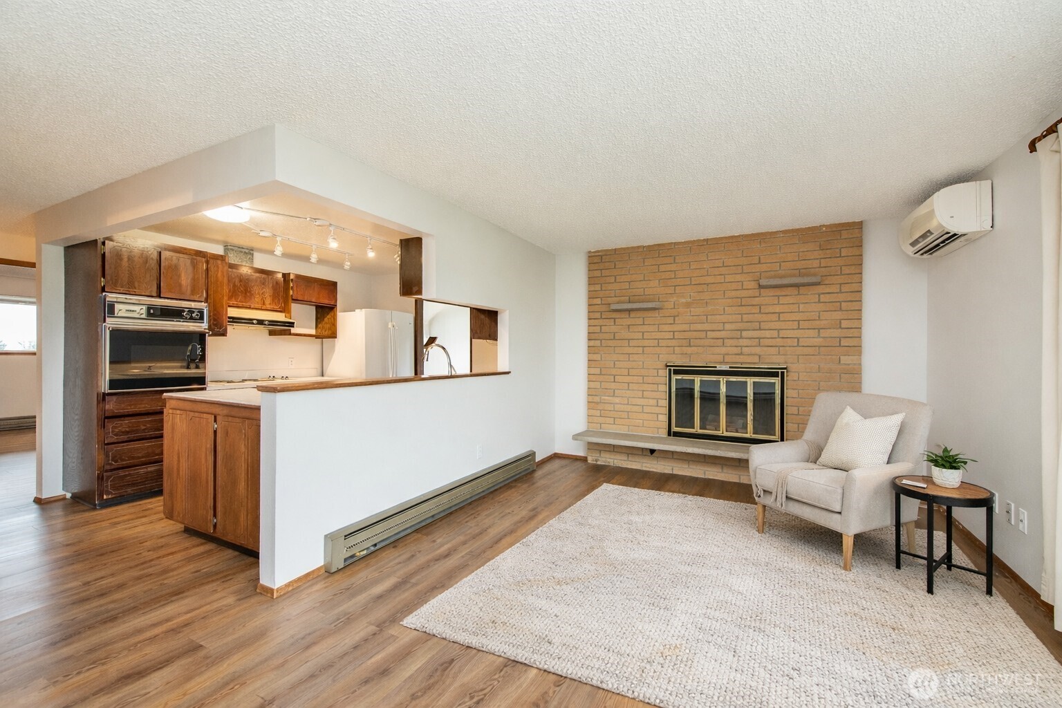 1301 South 3rd Avenue, Unit 19D Sequim, WA 98382 - Photo 17 of 35 a living room with stainless steel appliances kitchen island granite countertop a couch and a fireplace