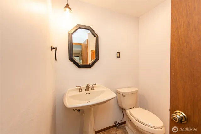 a bathroom with a toilet sink and mirror