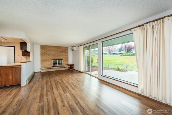 a view of a room with wooden floor and door
