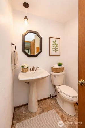a bathroom with a sink a mirror and a toilet