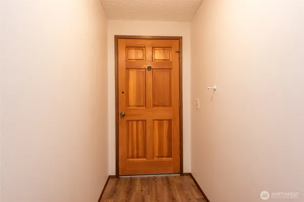 a view of a hallway with wooden floor